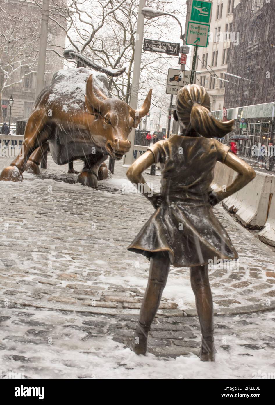 Fearless Girl statue in her previous location facing the Wall Street Bull, New York City USA Stock Photo