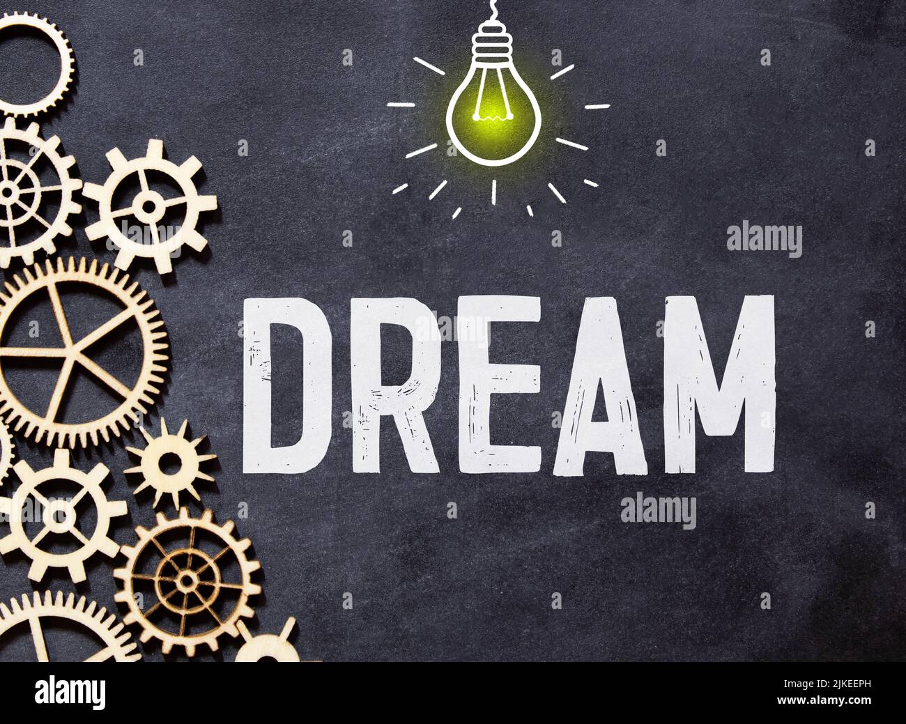 Word DREAMS with clothespins on black background. Dream visualization