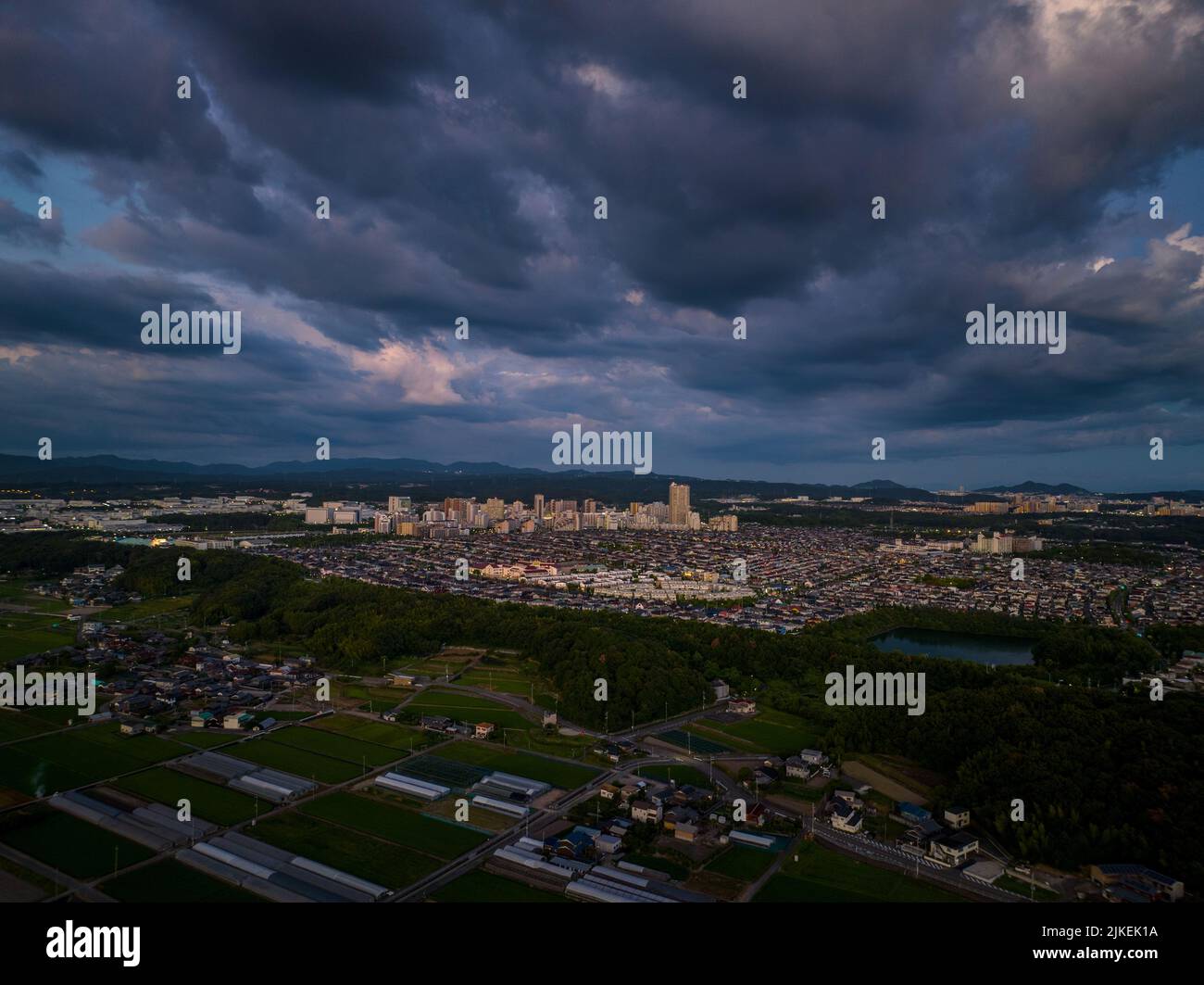 Dramatic clouds over small suburban development at dusk Stock Photo