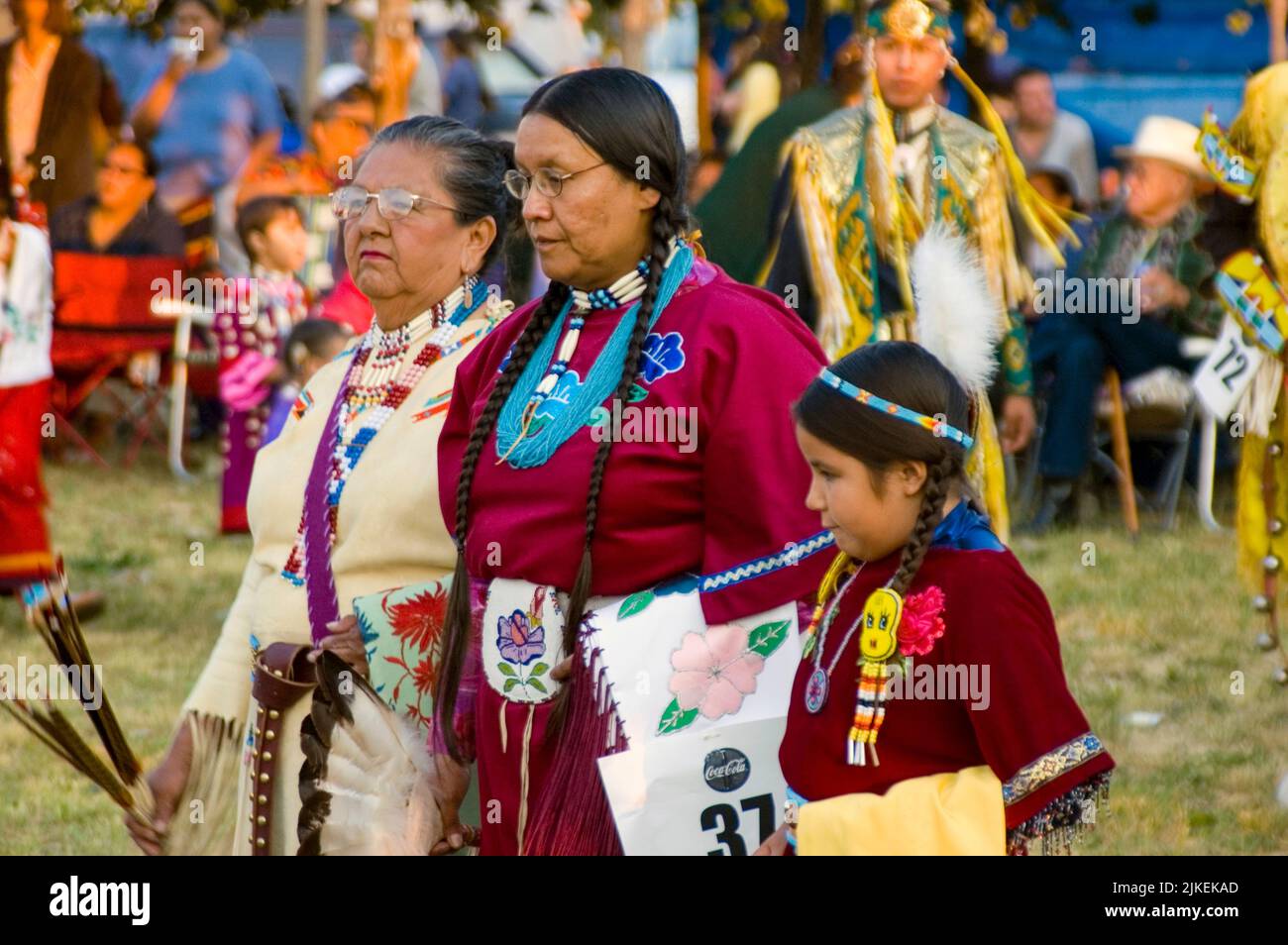 Grandmother, mother and daughter dressed in traditionally beaded