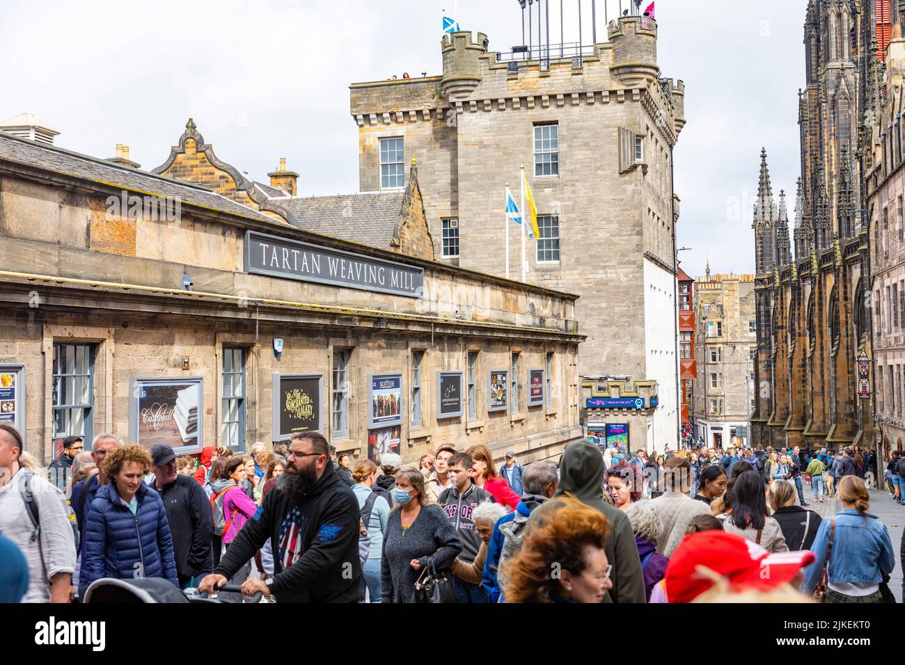 The Royal Mile Edinburgh in summer tourists crowd outside the Tartan weaving mill, tourism returns to Edinburgh after covid years,Scotland,summer 2022 Stock Photo