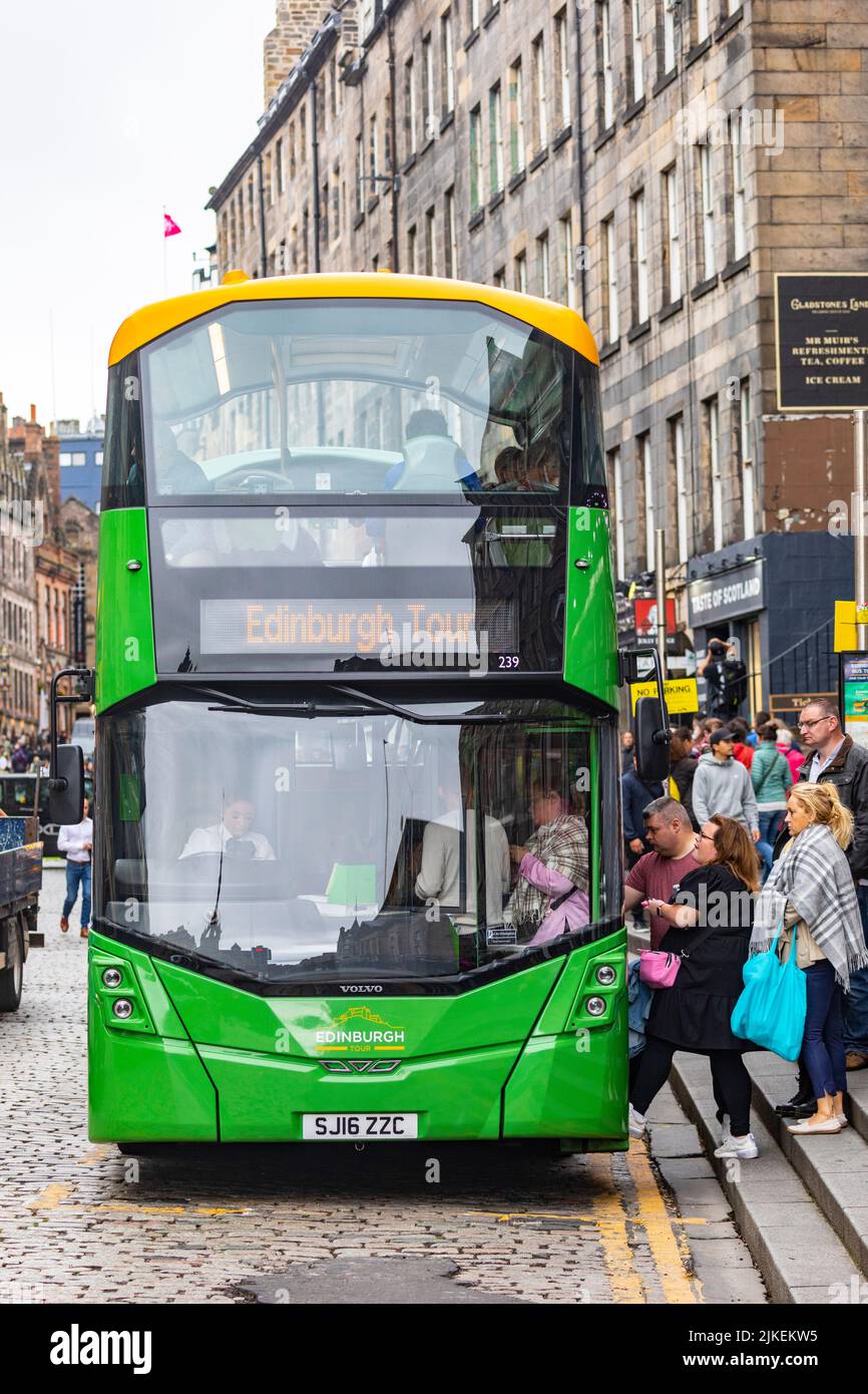 Edinburgh city centre and The Royal Mile, people embark Green sightseeing bus for tour around Edinburgh,Scotland,UK summer 2022 Stock Photo