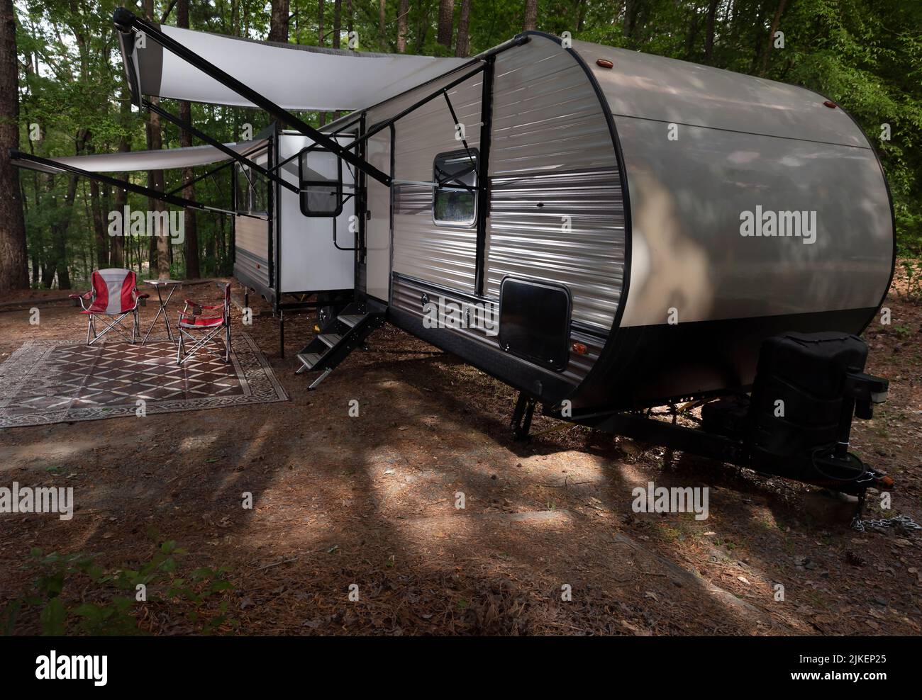 Camping trailer set up at Jordan Lake with both awnings out Stock Photo