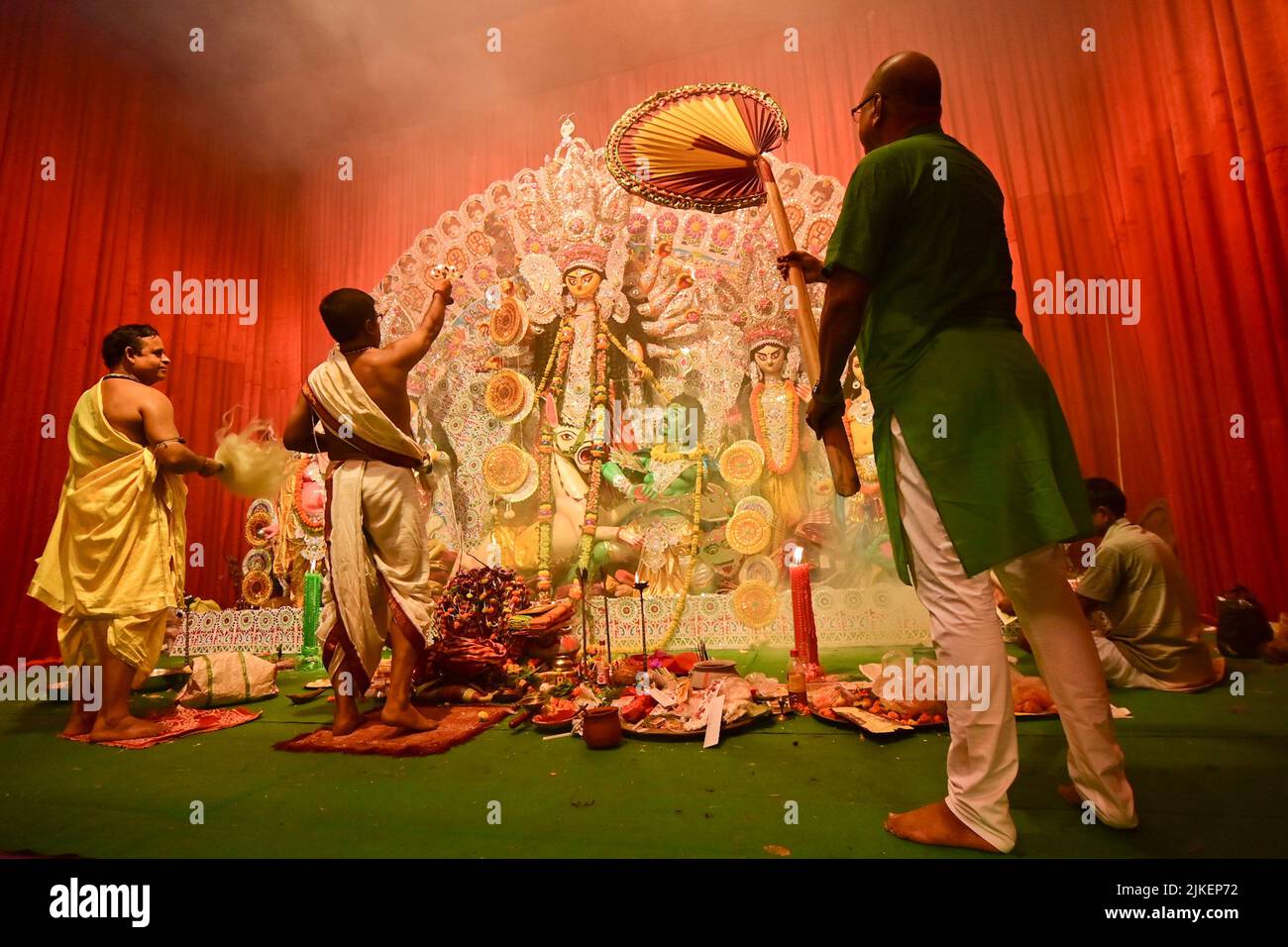 Howrah, India -October 13, 2021 : Hindu Priests worshipping Goddess Durga with panchapradip, ghanta, chamor and hand fan. Ashtami puja aarati event. Stock Photo
