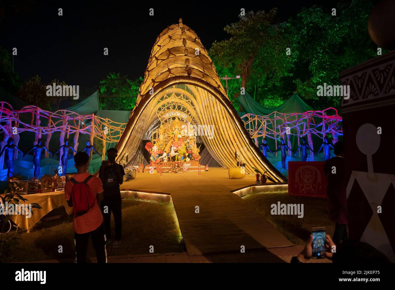 Kolkata, West Bengal, India - 12th October, 2021 : Devotees visiting decorated Durga Puja pandal at night. Biggest festival of Hinduism, worldwide. Stock Photo