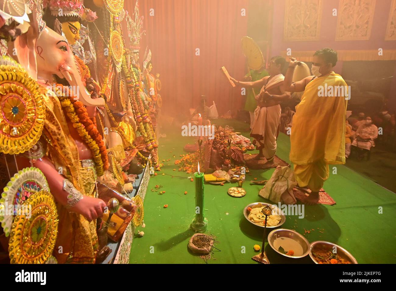 Howrah,India -October 13, 2021 : Hindu Priests worshipping Goddess Durga with ghanta, chamor and hand fan. Ashtami puja aarati - sacred ritual of puja Stock Photo