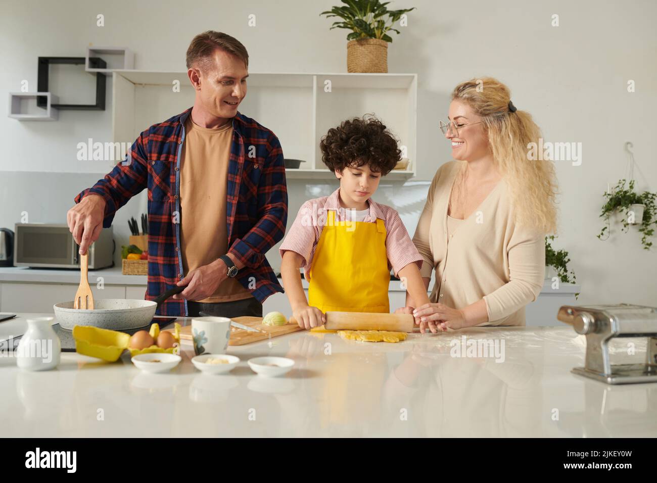 Joyful family cooking pasta at home for the first time Stock Photo - Alamy