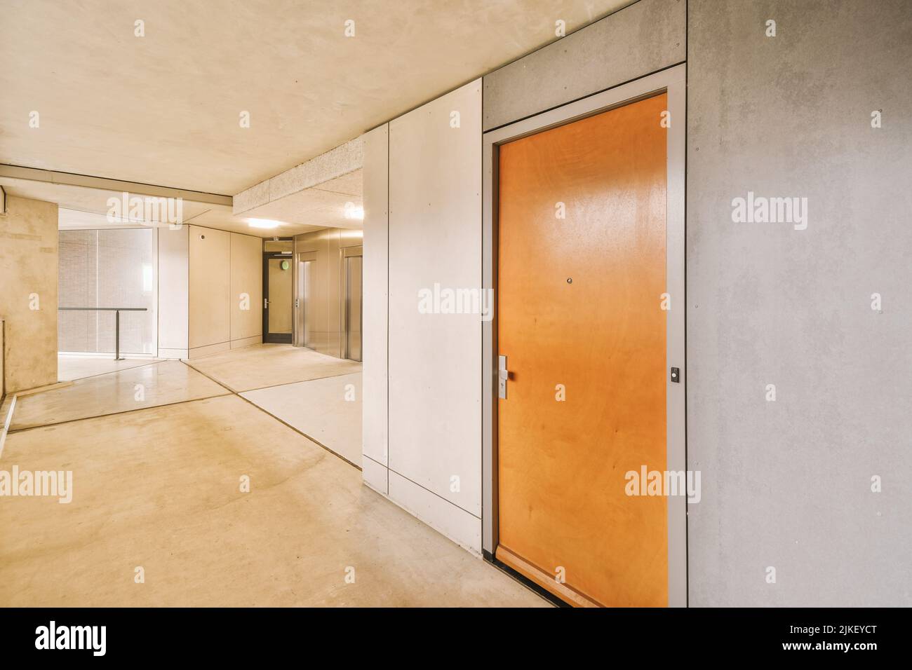 Shiny elevator in illuminated hall of contemporary apartment building with tiled floor Stock Photo