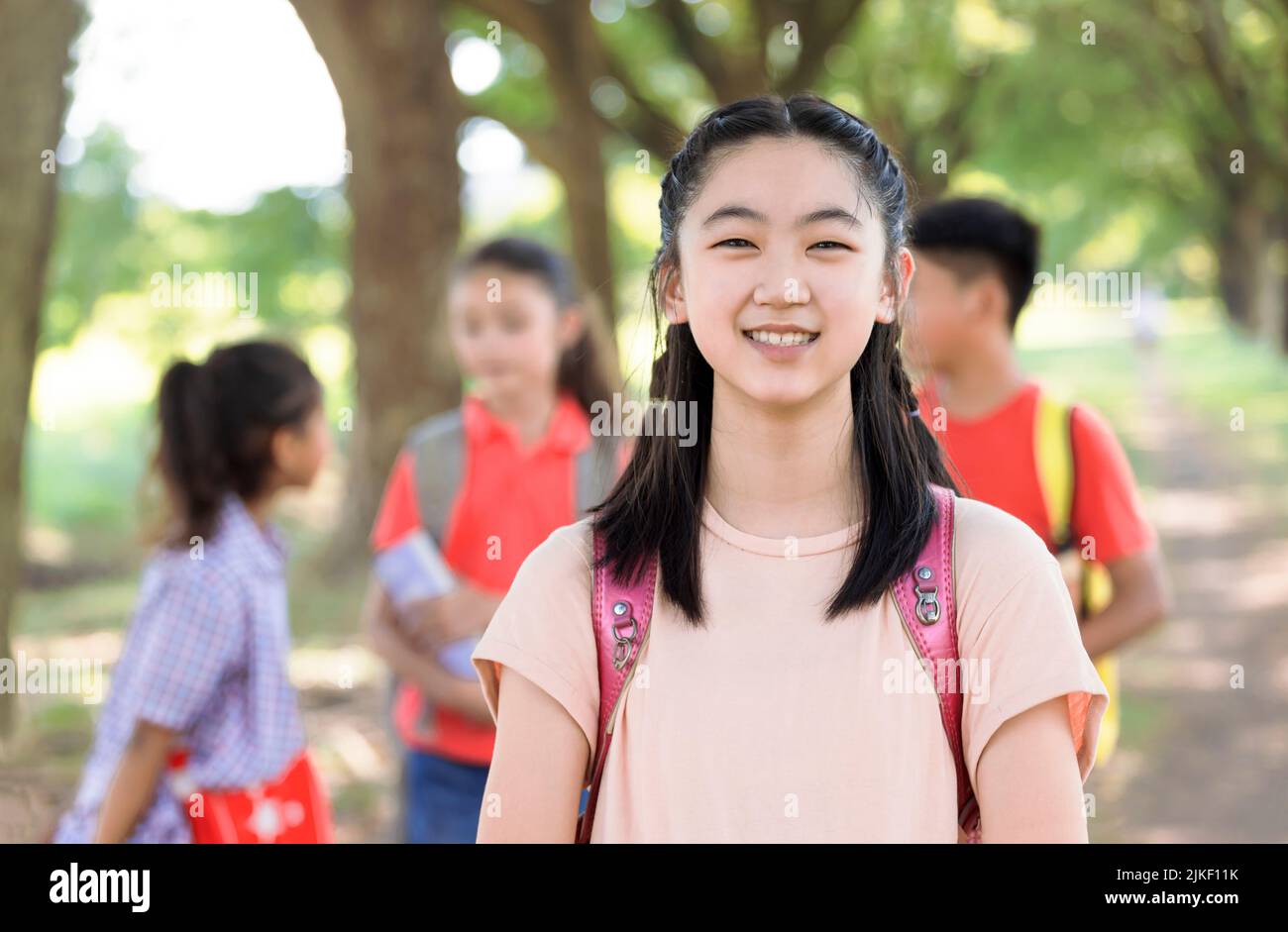Portrait of happy asian young girl outside the primary school Stock Photo