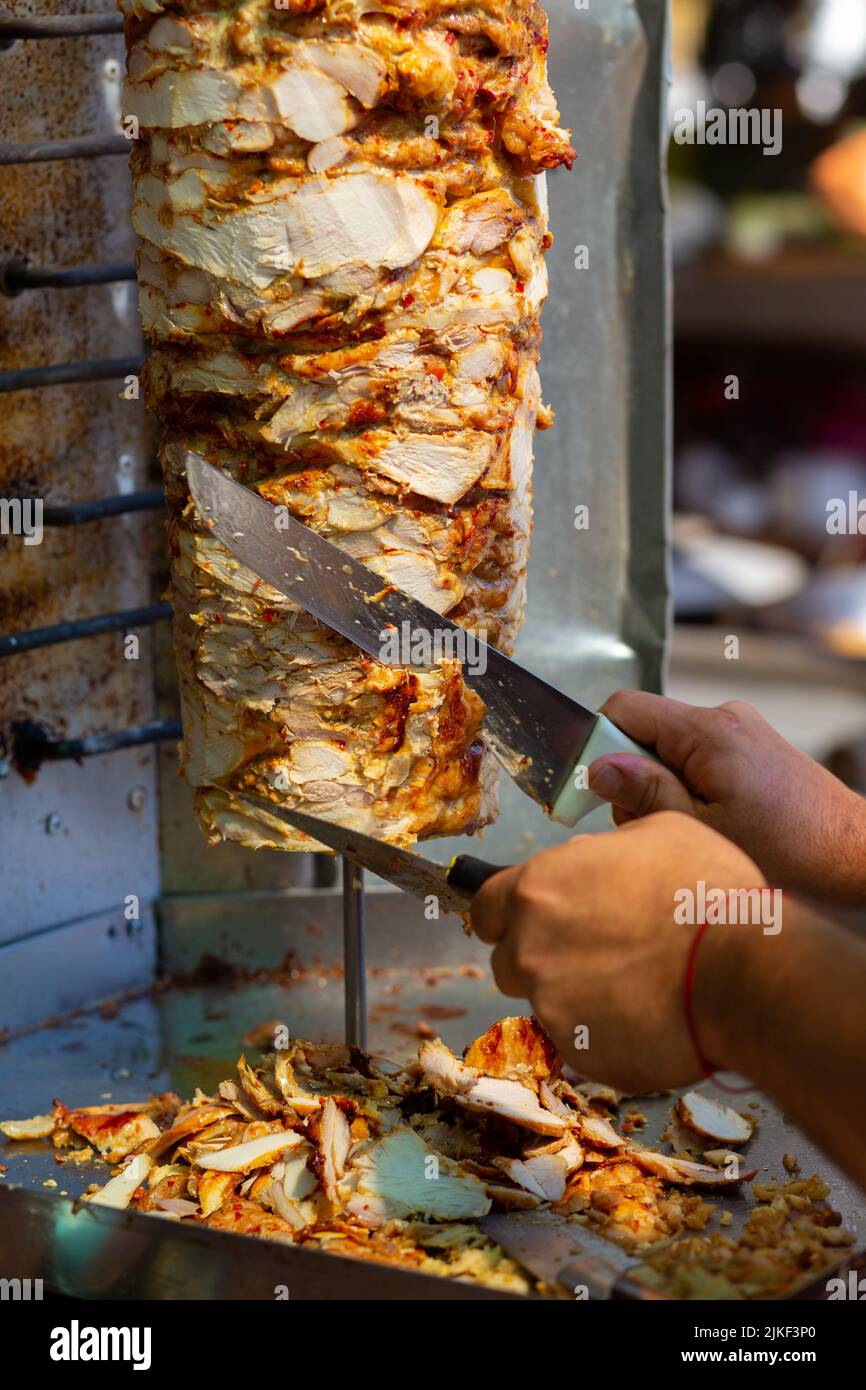 Chef cutting with doner knife Traditional Turkish Doner Kebab meat