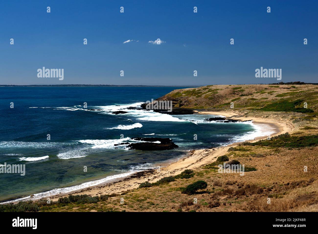 The sun shines on a deserted beach at Cowrie Bay on Phillip Island in Victoria, Australia, just a few days after the school holidays. Stock Photo
