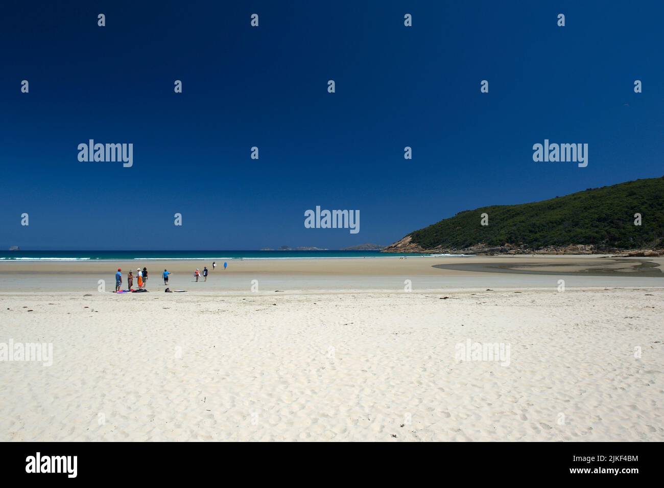 School holidays are over - and these lucky few are enjoying a party on the deserted white sands of Norman Beach at Tidal Inlet on Wilsons Prom. Stock Photo