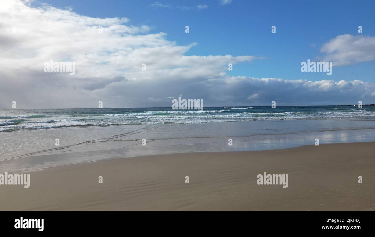 An empty scenic beach under a cloudy sky Stock Photo - Alamy