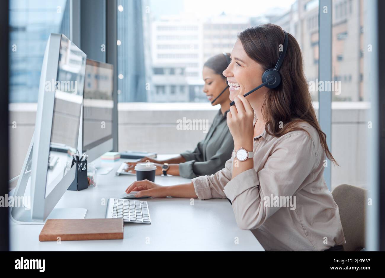 Hi there how may i help you two young female call center workers in