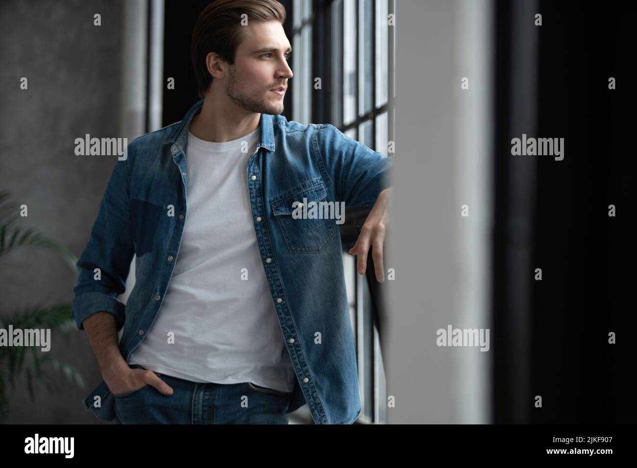 Image of a positive smiling young man indoors at home Stock Photo - Alamy
