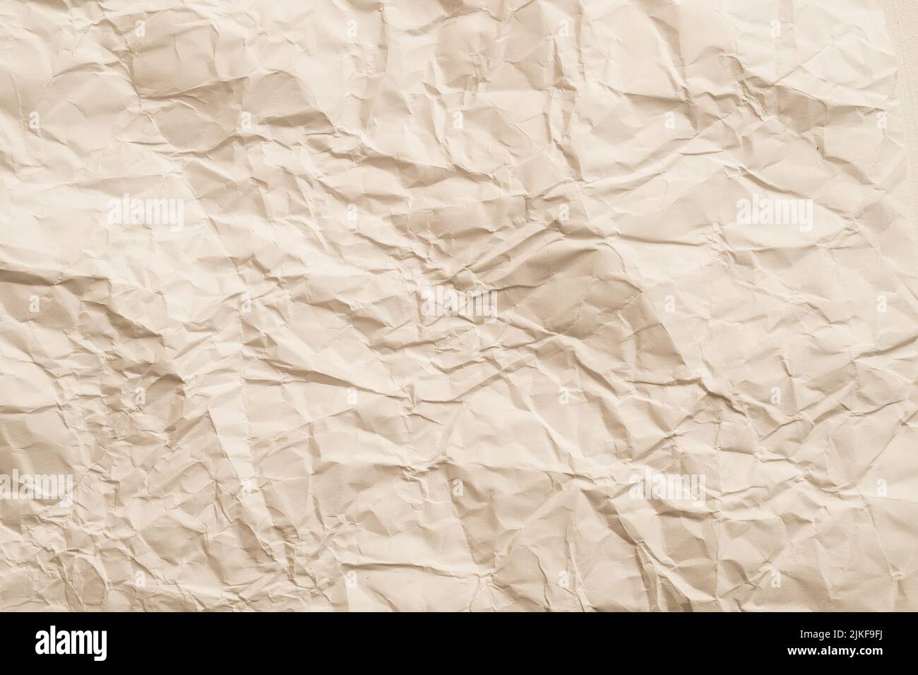 ivory crumpled paper wrinkled texture background Stock Photo