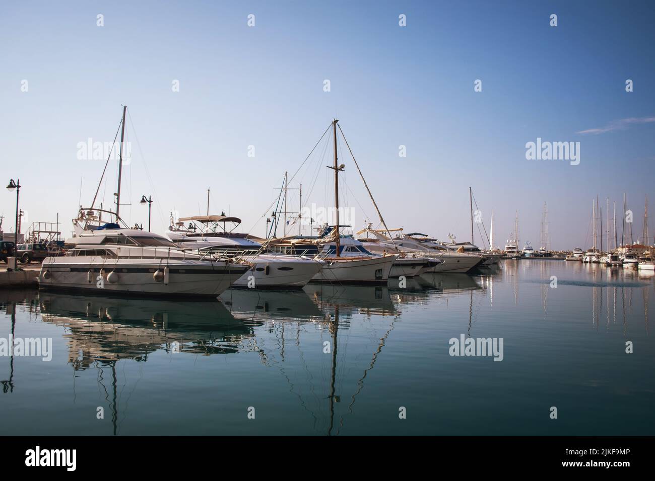 Luxury white yachts against the blue sky in the harbor of the port of