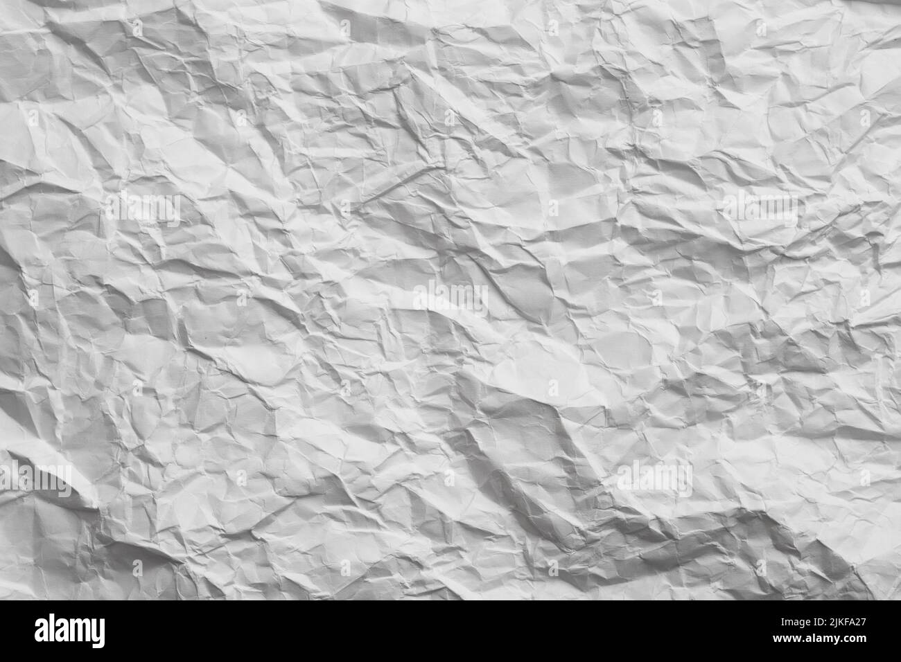 gray toned white crumpled paper creased background Stock Photo