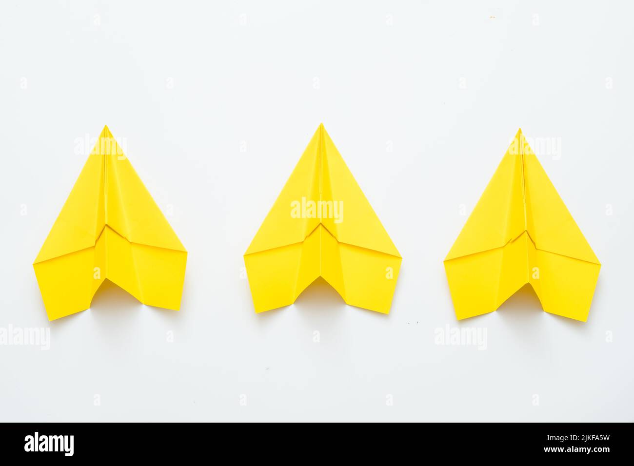 team spirit ambition three yellow paper airplanes Stock Photo