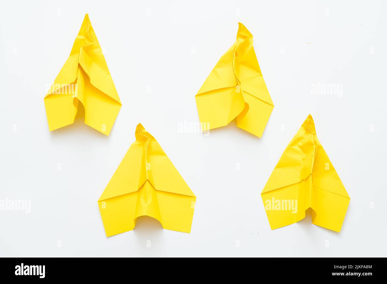 persistence motivation yellow creased paper planes Stock Photo