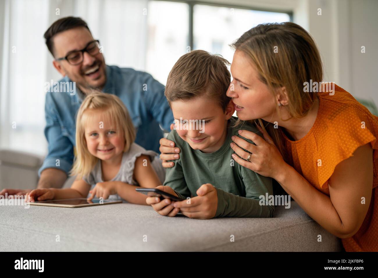 Device technology family online education concept. Happy family with ...
