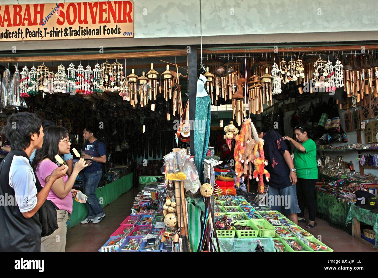 Tourists are photographed at a souvenir shop on the side of a road leading to Kinabalu Park in Sabah, Malaysia. Stock Photo