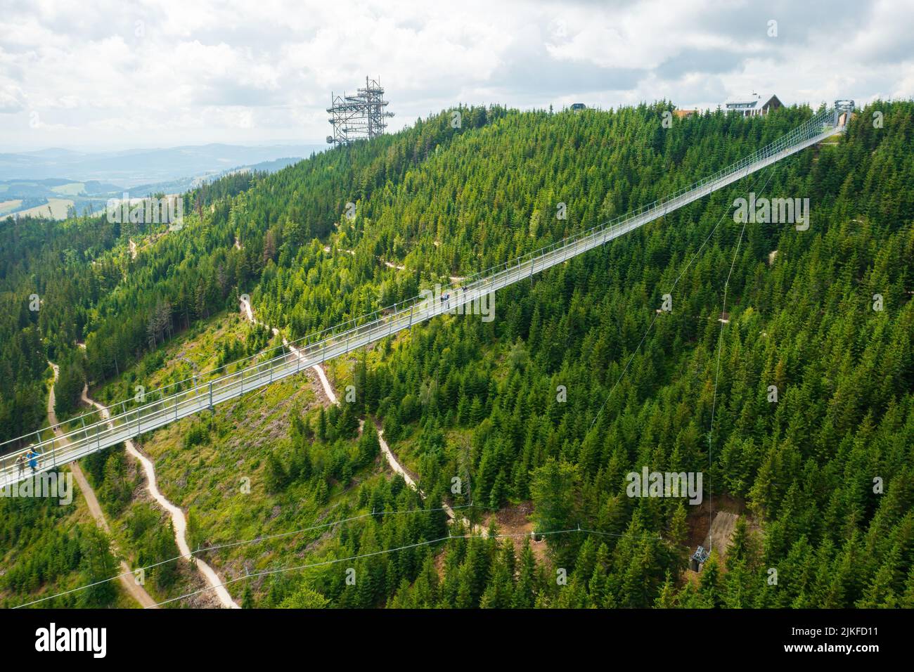 Aerial view of the worlds longest 721 meter suspension footbridge Sky bridge and observation tower the Sky walk in the forest, between mountains, Dolni Morava Ski Resort, Czech Republic.  Stock Photo