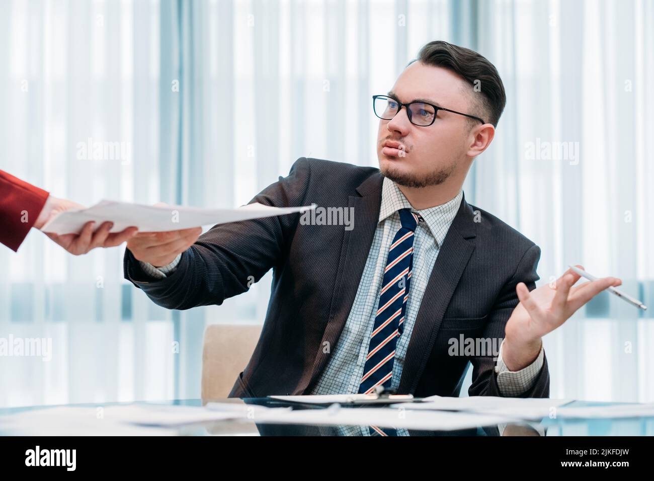 dissatisfied grumpy boss document irritable man Stock Photo