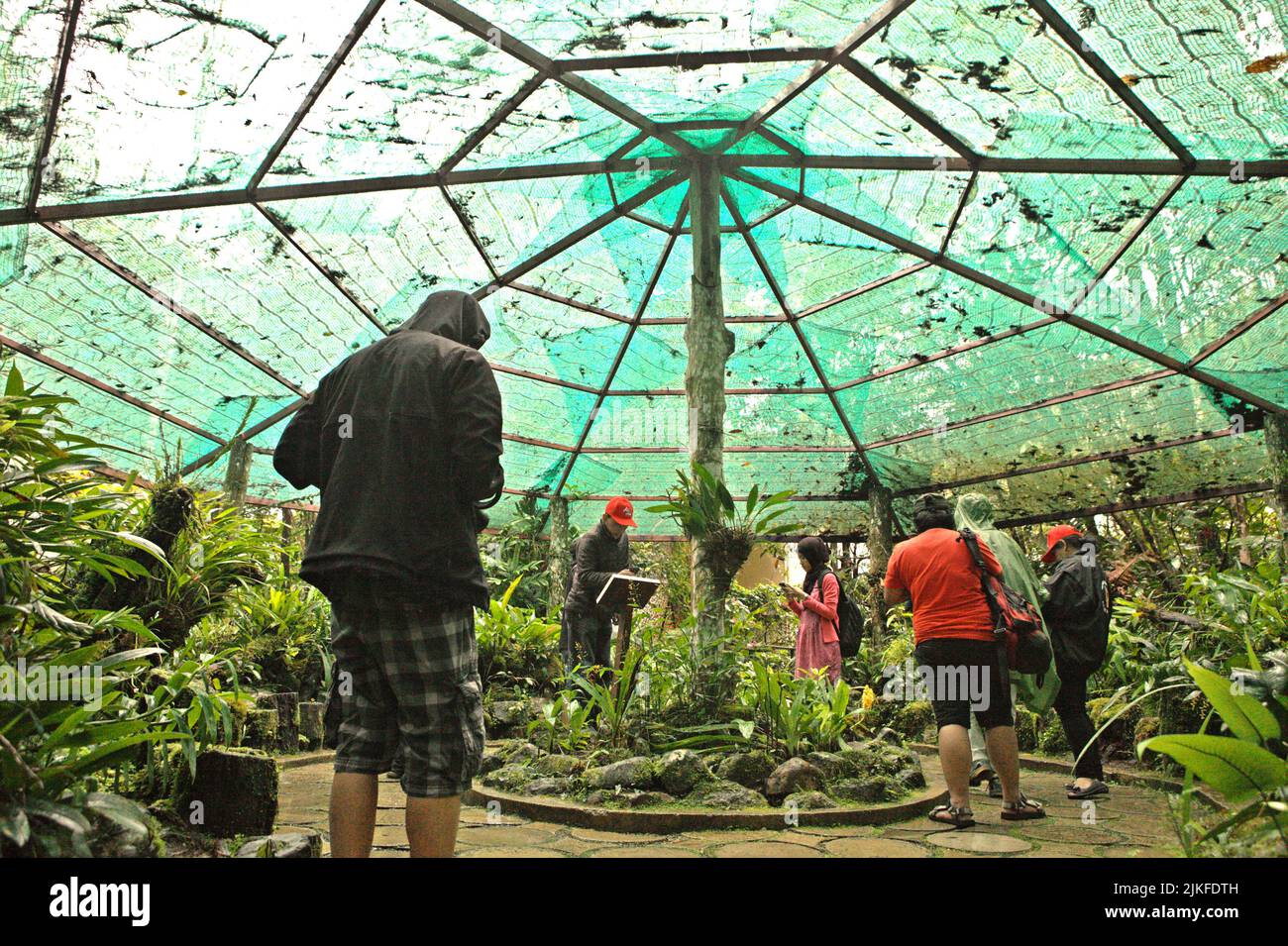 Visitors having a recreational time below a canopy net at Mount Kinabalu Botanical Garden in Kinabalu Park, Ranau, Sabah, Malaysia. Stock Photo