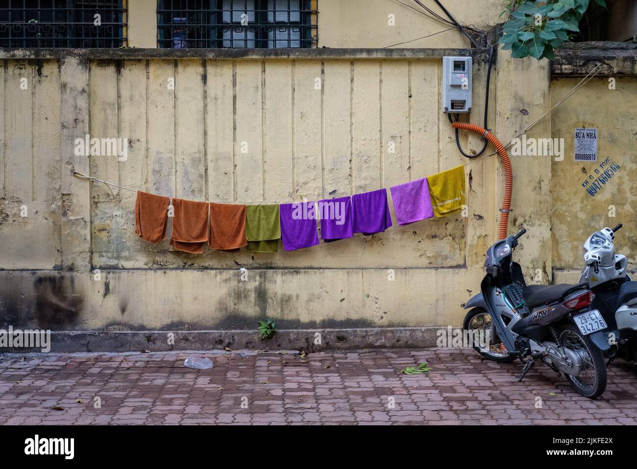 HANOI, VIETNAM - JANUARY 5, 2020: Laundry hanging to dry in the streets of Hanoi, Vietnam on January 5, 2020. Stock Photo