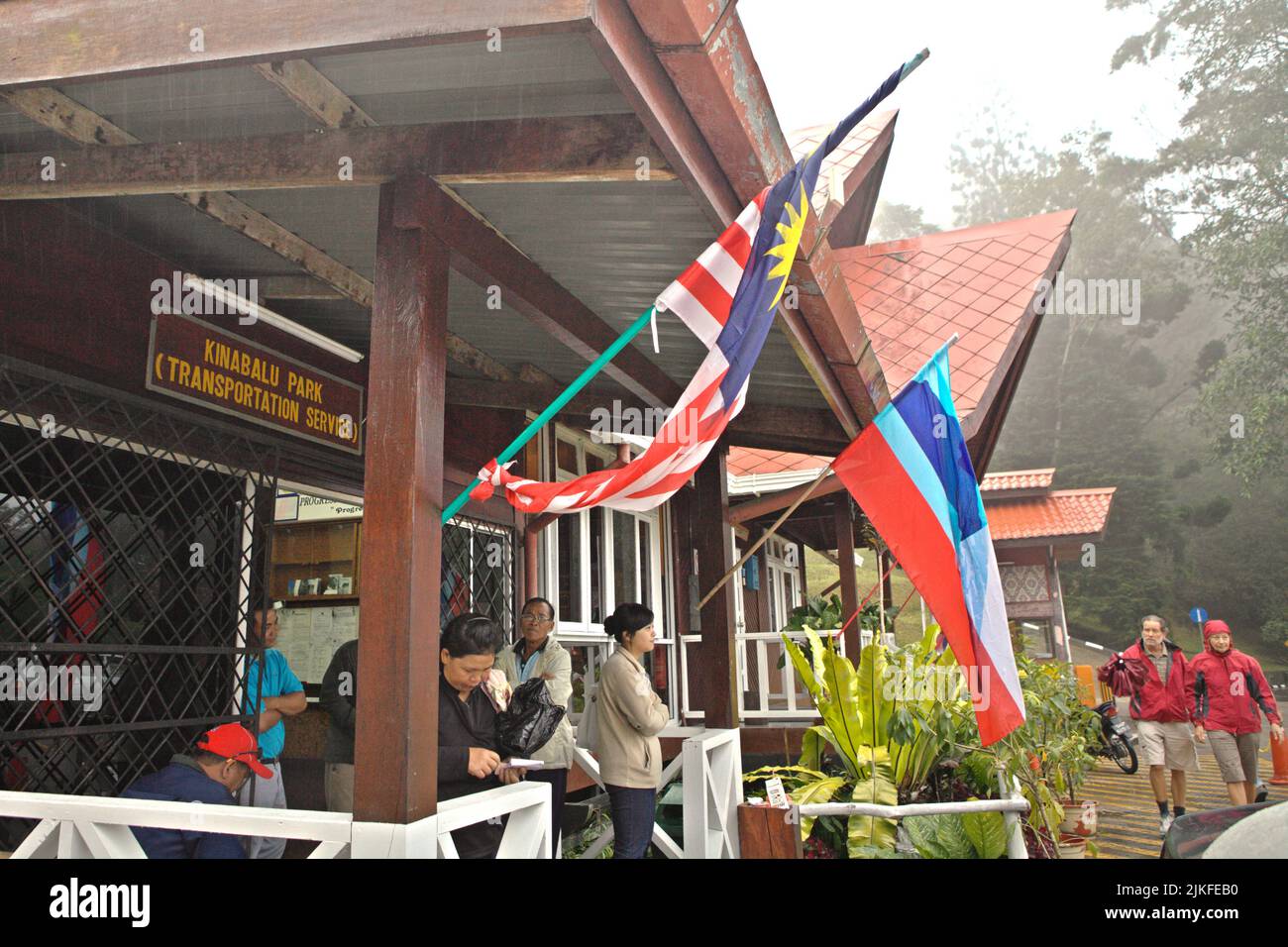 Visitors waiting at a transportation service station in Kinabalu Park, Ranau, Sabah, Malaysia. Stock Photo