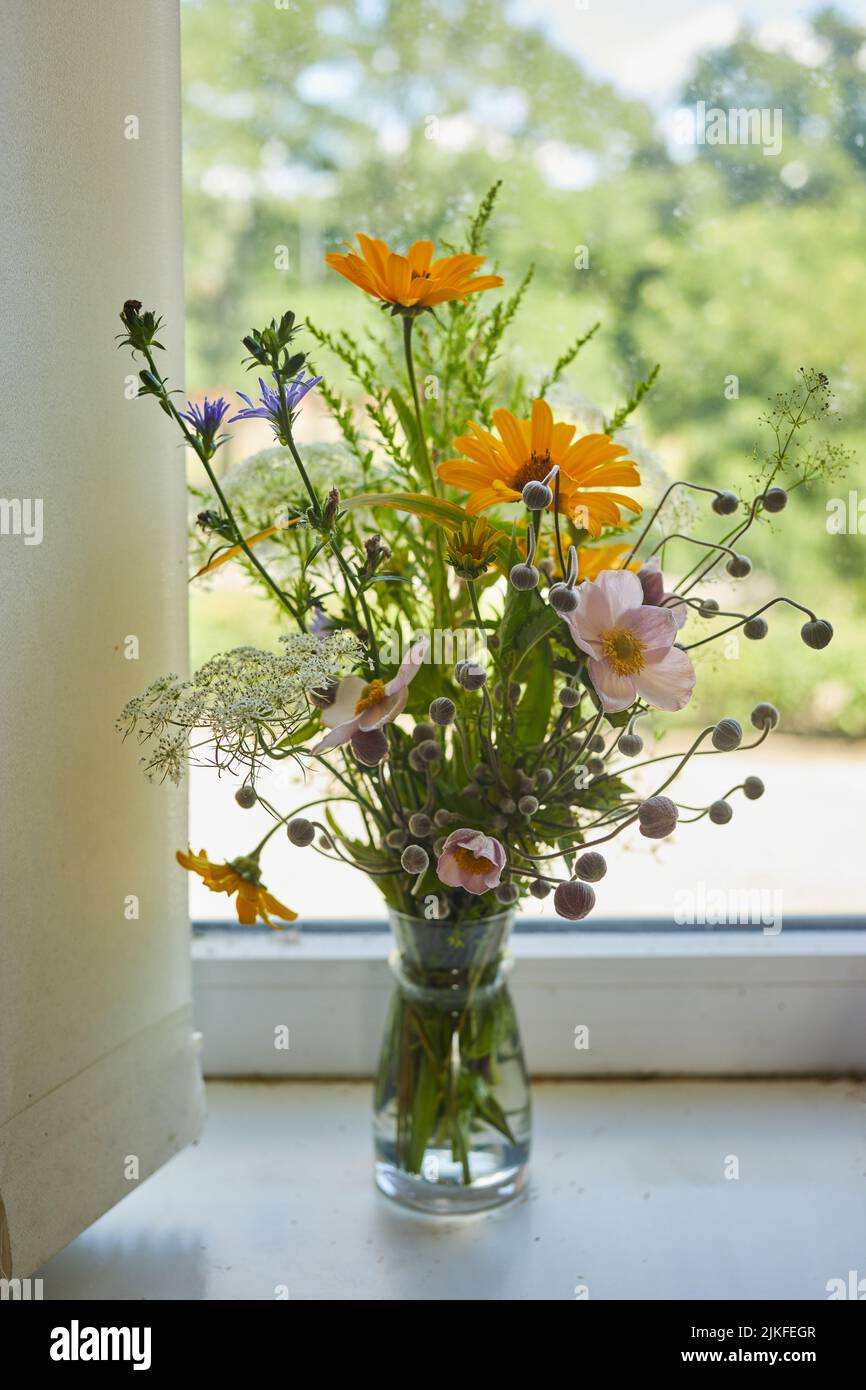 Beautiful bouquet of wildflowers isolated on windowsill Stock Photo