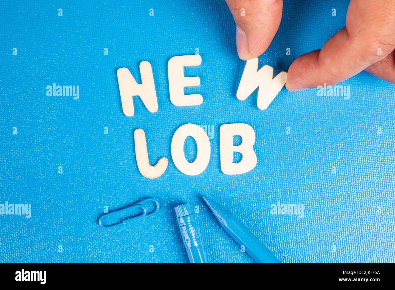 New Job. Text from white wooden letters on a blue background. Stock Photo