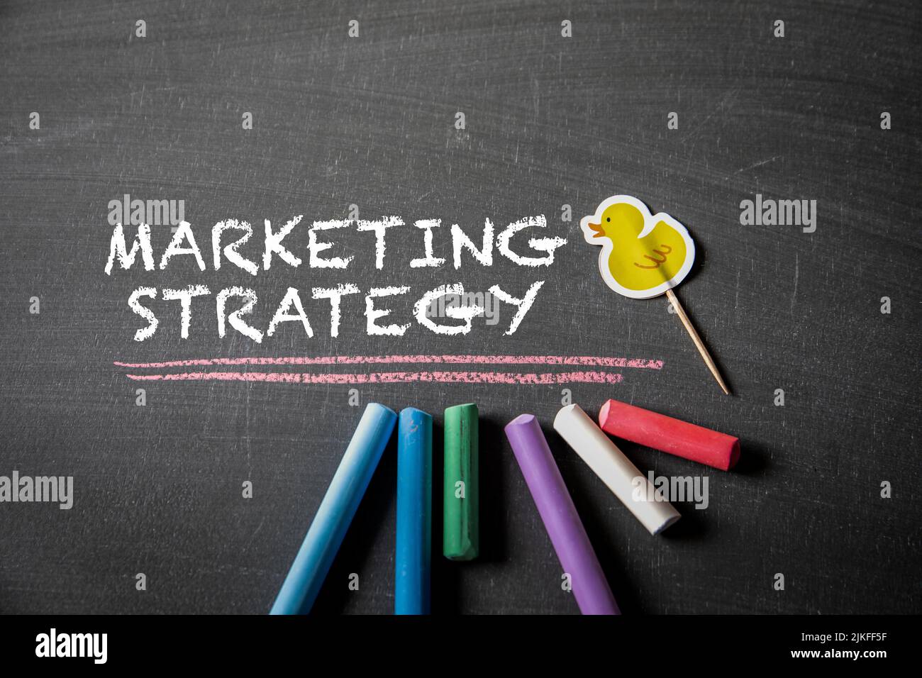 Marketing Strategy. Text on black chalk board. Stock Photo
