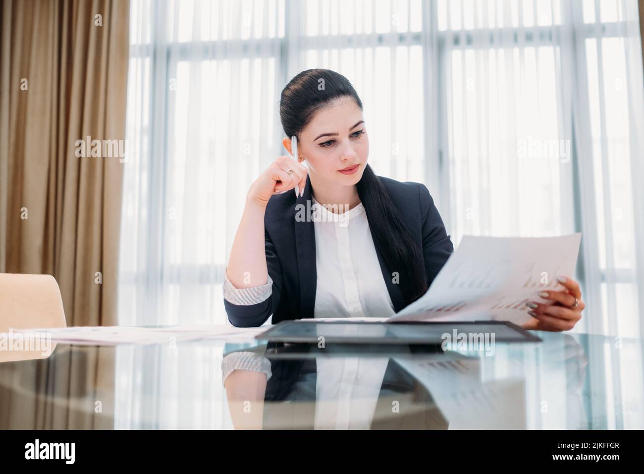 pensive business woman read document office Stock Photo
