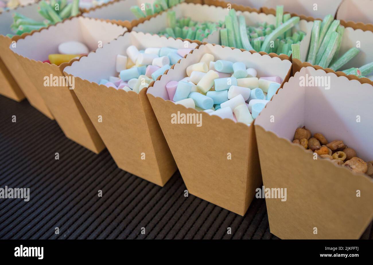 Cardboard baskets full of candies and salad snacks. Candy buffet or Candy bar for celebrations Stock Photo