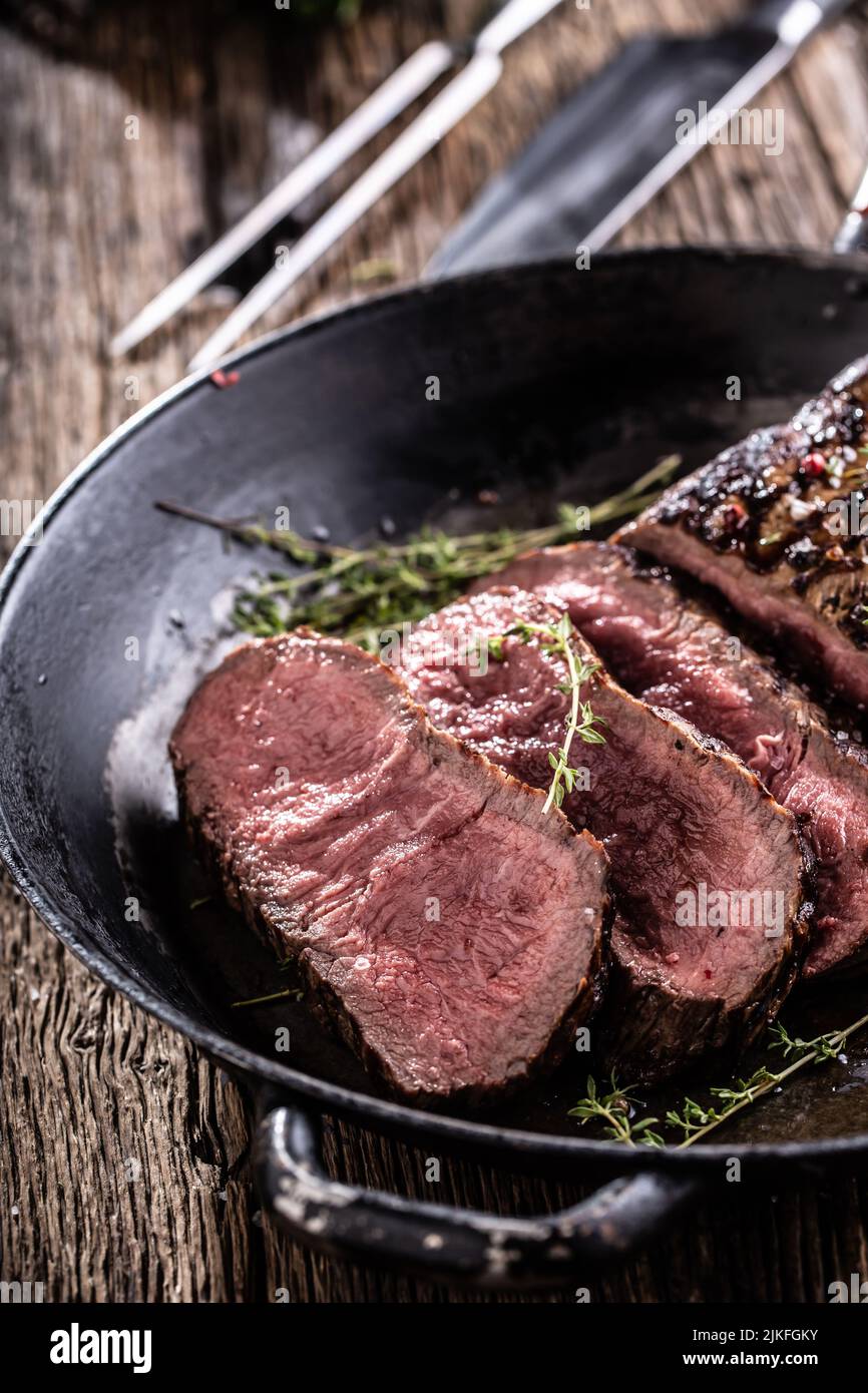 Grilled beef steak in a pan with herbs. Stock Photo