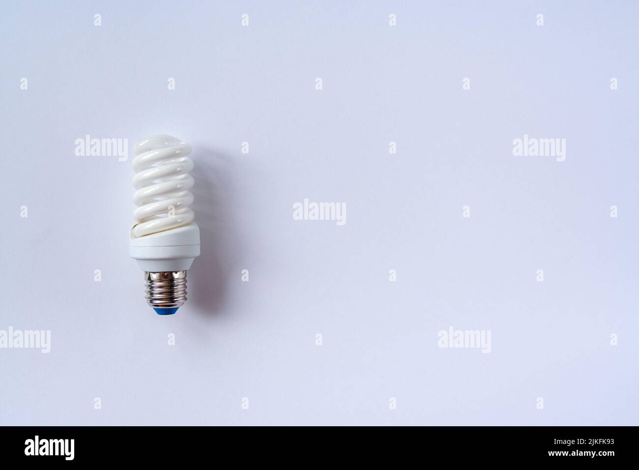 Energy saving light bulb on a blue background Stock Photo - Alamy