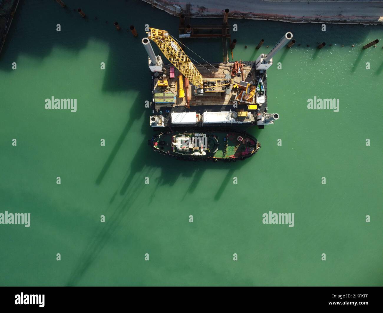Floating crane dredging barges working on the construction of a marina