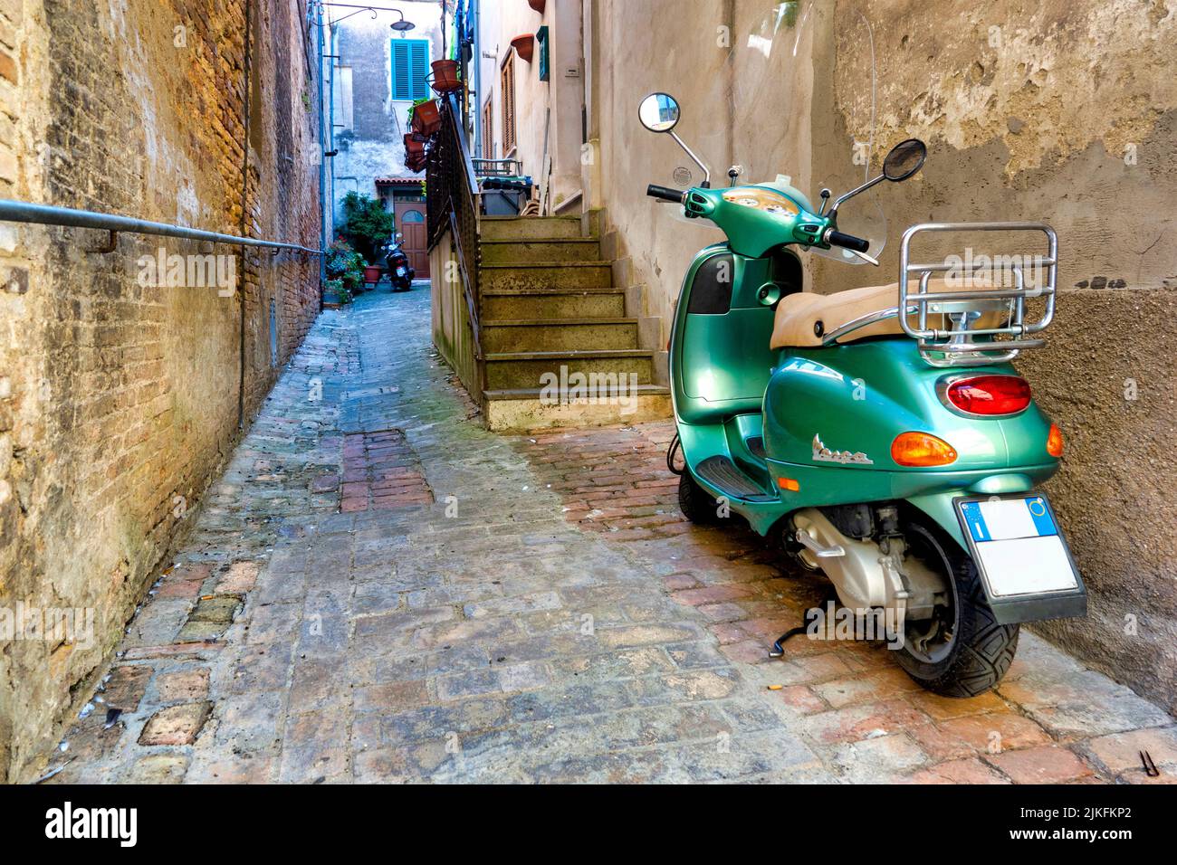 Green Vespa in a small alley in Penne, Italy Stock Photo