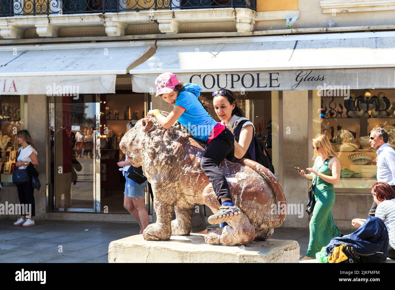VENICE, ITALY - MAY 18, 2018: Unidentified people are played near the historical sculptures of lions in the Piacenza Leoncini. Stock Photo
