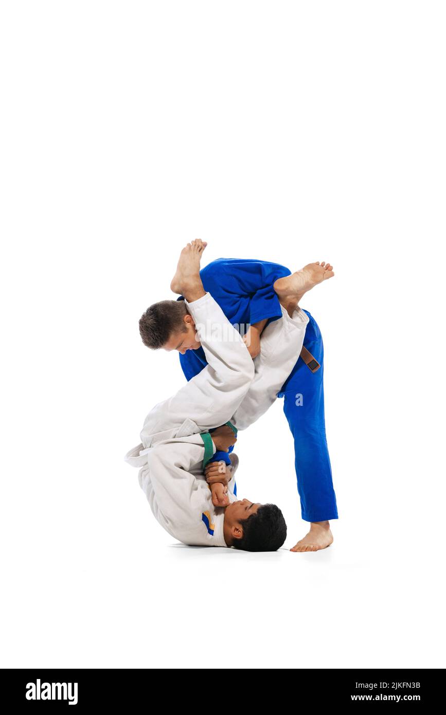 Two men in special uniform, martial arts athletes training isolated
