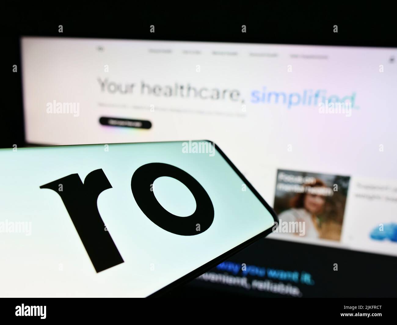 Mobile phone with logo of telehealth company Roman Health Ventures Inc. (Ro) on screen in front of website. Focus on center of phone display. Stock Photo