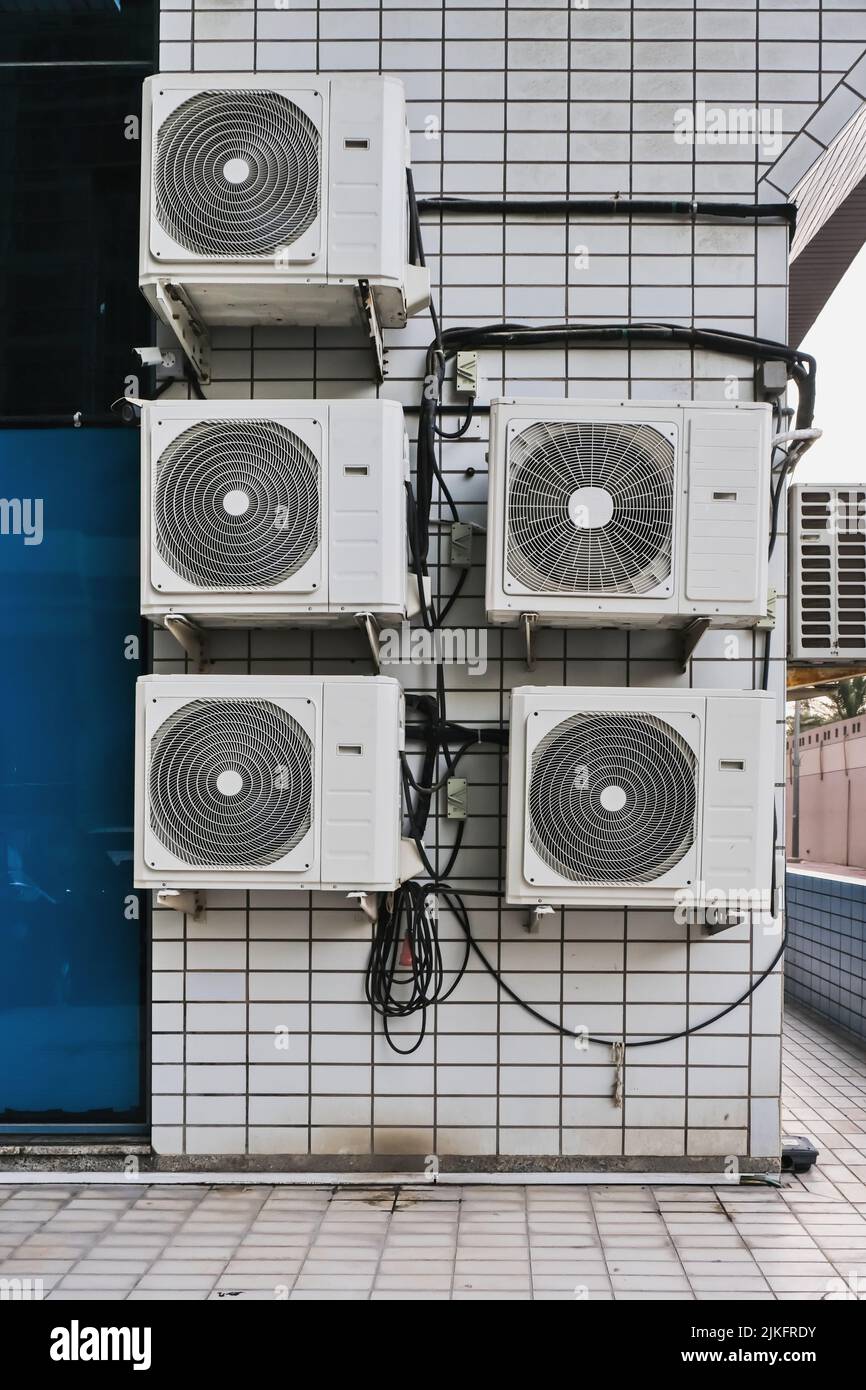 Group of outer air conditioners on wall of residential building. Maintenance house facilities.Climate technology. Stock Photo
