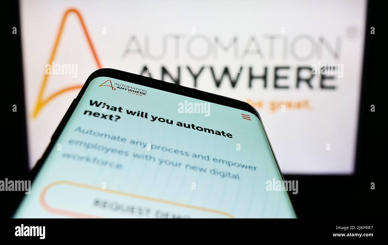 Mobile phone with website of US software company Automation Anywhere Inc. on screen in front of business logo. Focus on top-left of phone display. Stock Photo