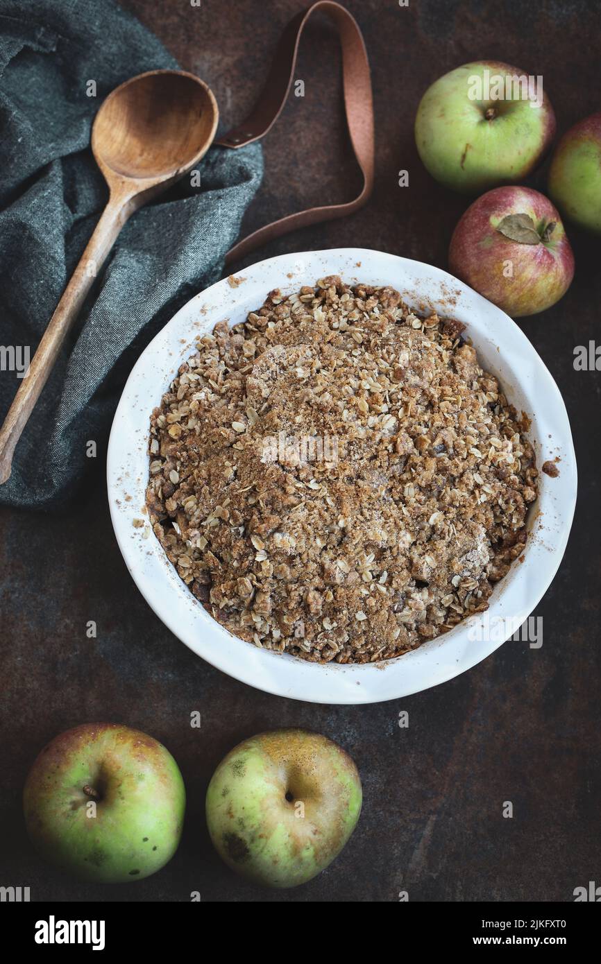 Fresh hot homemade apple crisp or crumble with crunchy streusel topping topped with blurred background and foreground. Top view. Stock Photo