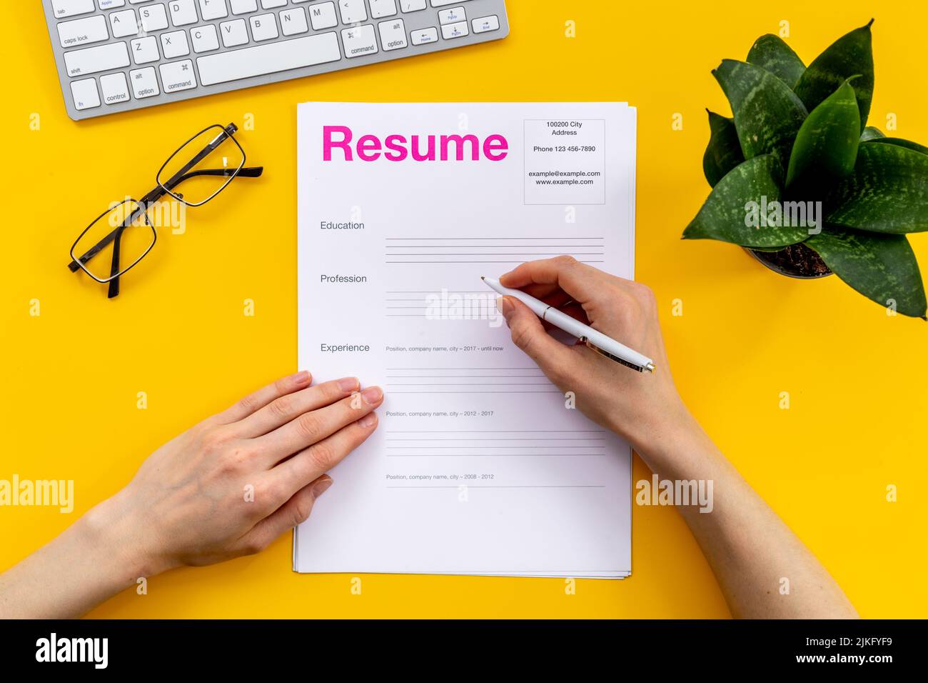 Employer reviews resume application - Employer Reviews Resume Application Form On Office Table 2JKFYF9 