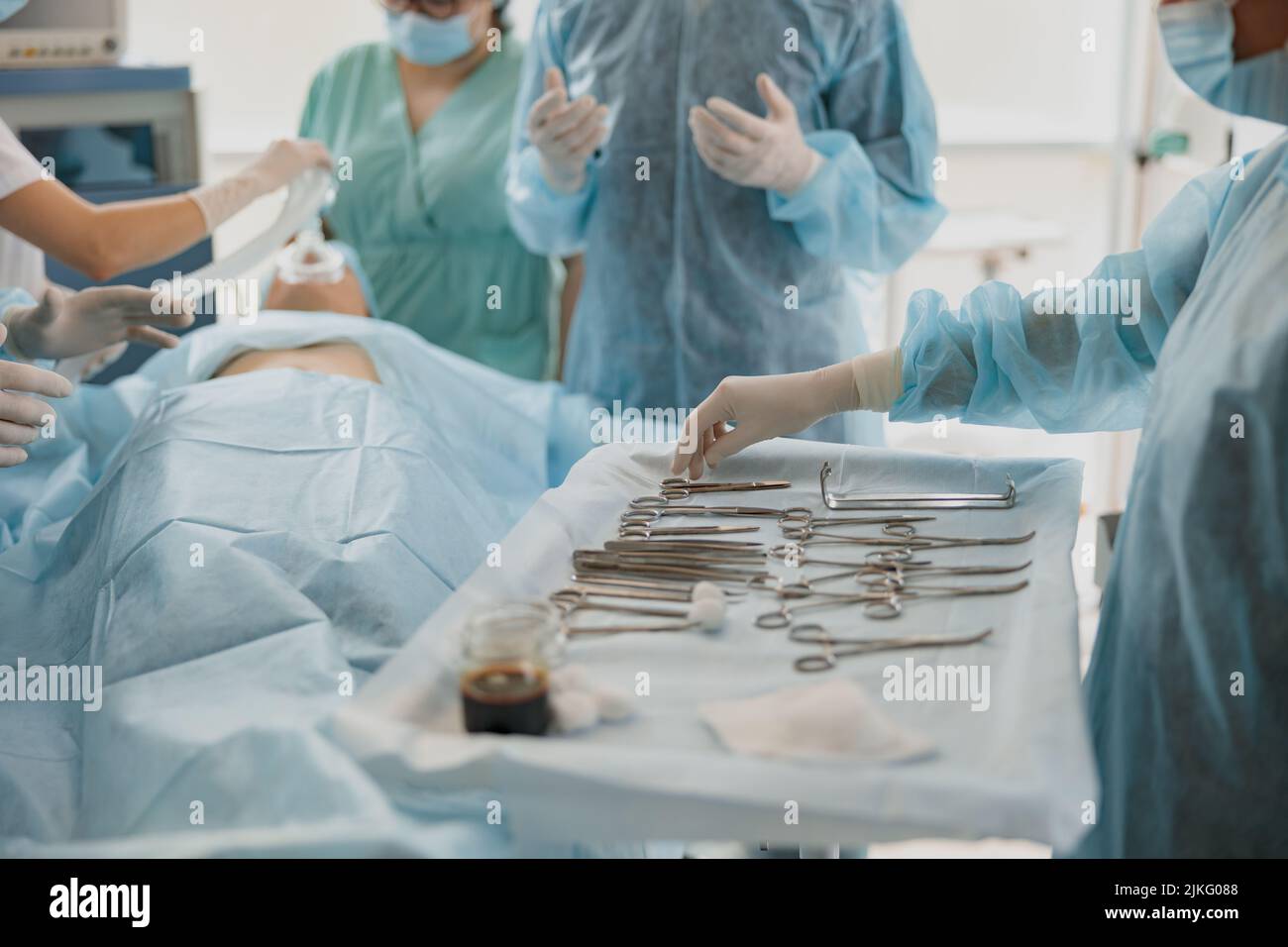 Close up of assistant submits instrument to doctor during operation. Healthcare and medical concept Stock Photo