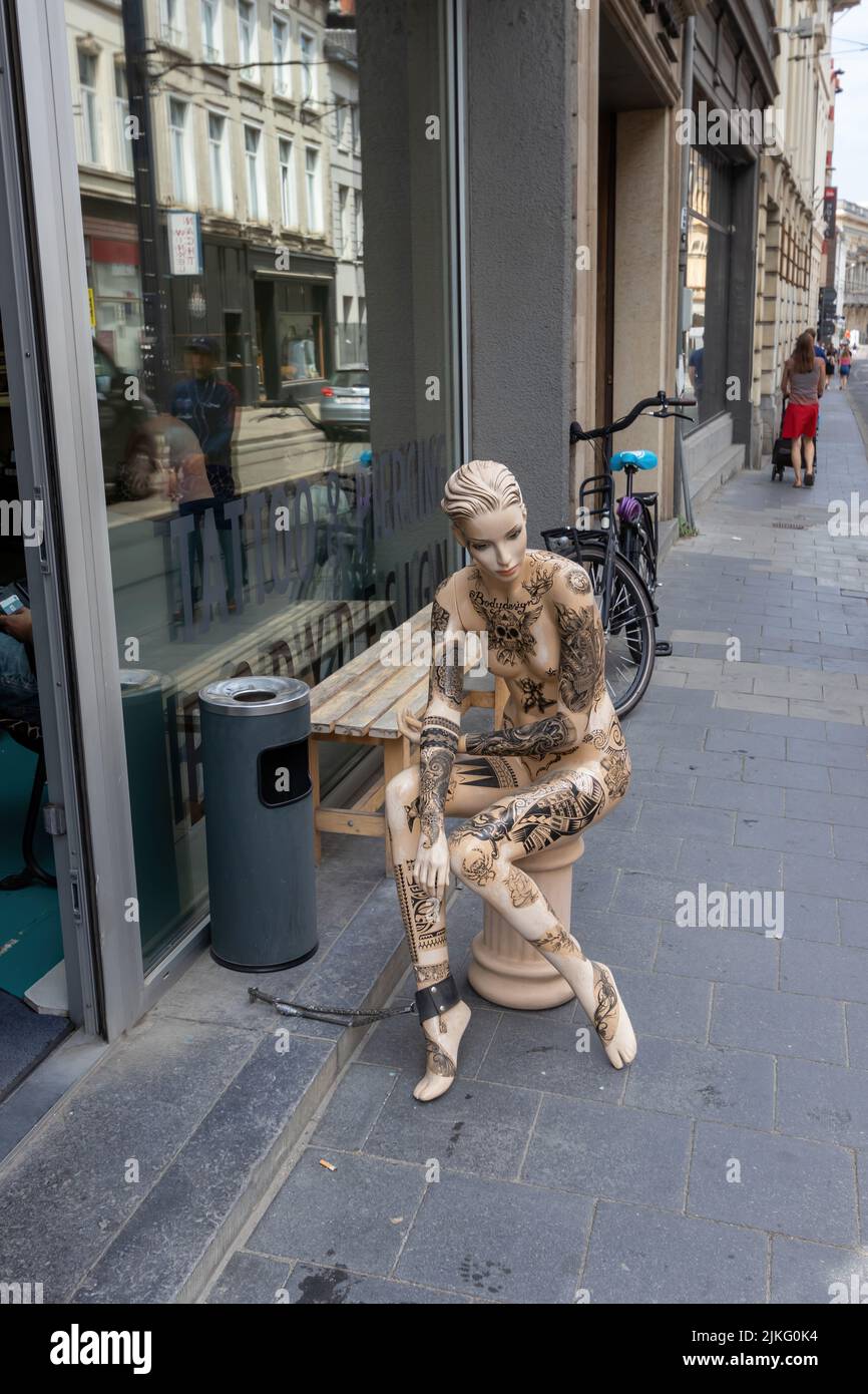 Ghent, Belgium - July 13, 2018: A decorated female mannikin at the entrance to the tattoo studio Stock Photo