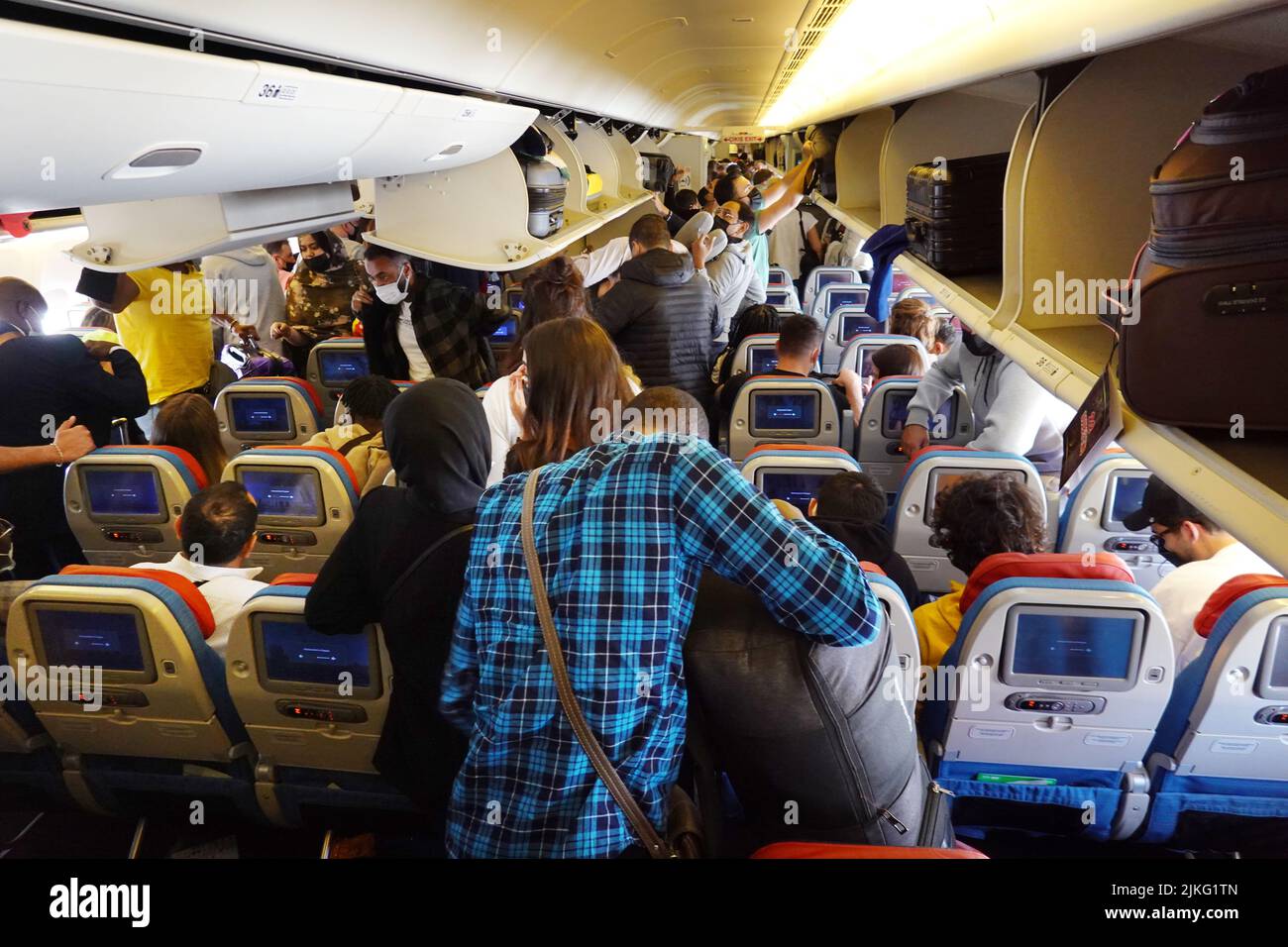 27.03.2022, Turkey, , Istanbul People retrieve carryon luggage from